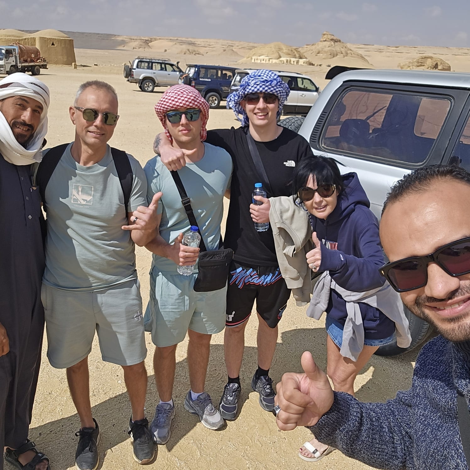 A small group with Tarek beside their 4x4 vehicles in the Fayoum desert