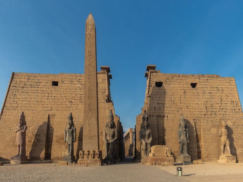 The obelisk and seated statues of Ramesses II at the entrance of Luxor Temple